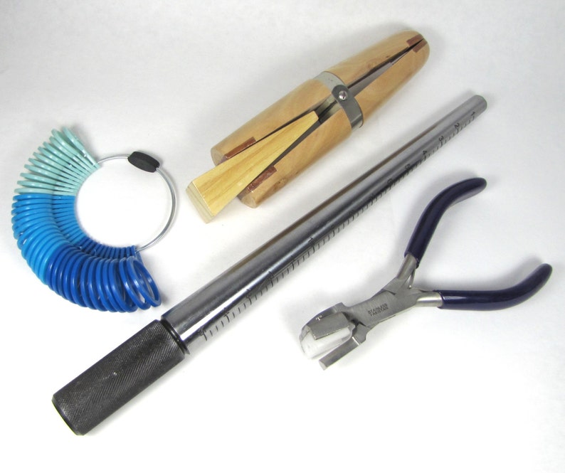May include: A set of jewellery making tools including a ring mandrel, ring sizer, and a pair of pliers with a blue handle.