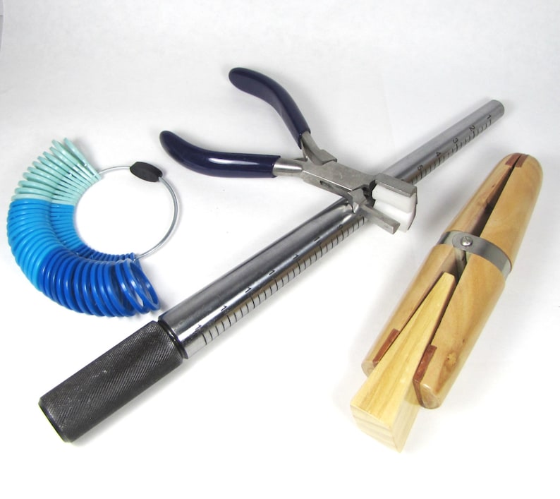 May include: A set of jewellery making tools including a ring mandrel, ring sizer, and a pair of pliers with blue handles.