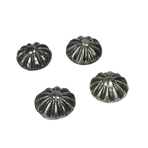 May include: Four silver-toned metal decorative nail heads with a raised, starburst design.