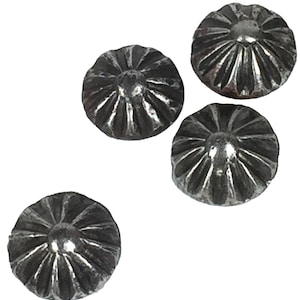 May include: Four silver-toned metal decorative nail heads with a raised, starburst design.