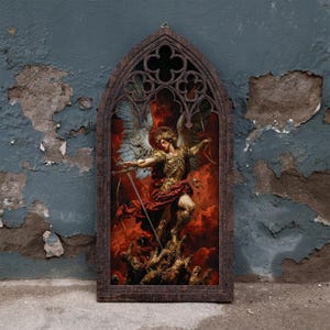 May include: A rectangular wall hanging with an arched top featuring a dark brown wooden frame with gothic-style cutouts. The centre displays a vibrant illustration of a winged figure in golden armour holding a sword amidst red clouds and flames.