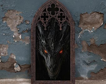 May include: A rectangular wall hanging featuring a dark, textured wooden frame with a pointed gothic arch top. Inside the frame is a detailed illustration of a black dragon with glowing red eyes and sharp scales, set against a dark background.