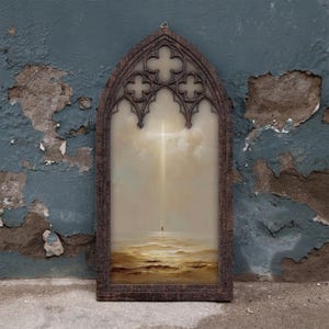 May include: A tall, arched wooden frame with intricate gothic-style tracery at the top, enclosing a painting of a solitary figure standing on a vast, textured golden landscape beneath a bright, vertical beam of light descending from the clouds.