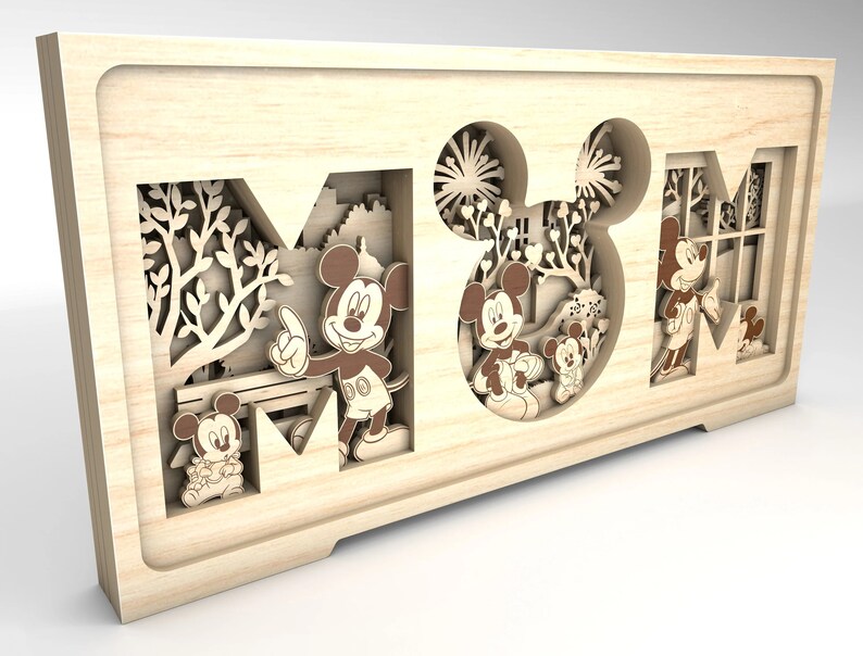 May include: Wooden wall art featuring the word "MOM" with a Mickey Mouse theme. The letters are cut out and layered, creating a 3D effect. Mickey Mouse and his friends are depicted in the cutouts, with a park scene in the background.