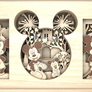 May include: A wooden cutout of Mickey Mouse with a castle and fireworks in the background. The cutout is a 3D design with multiple layers.