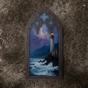 May include: A dark wood-framed wall art piece featuring a pointed gothic arch top. The painting depicts a lighthouse on a rocky cliffside overlooking a turbulent, dark blue ocean under a stormy purple sky with a glowing yellow light at the top.