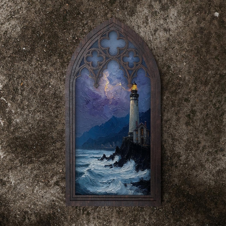 May include: A dark wood-framed wall art piece featuring a pointed gothic arch top. The painting depicts a lighthouse on a rocky cliffside overlooking a turbulent, dark blue ocean under a stormy purple sky with a glowing yellow light at the top.