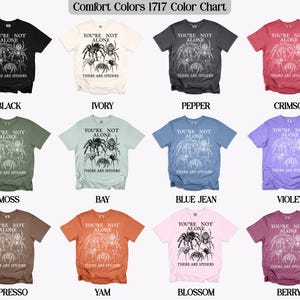 Comfort Colors 1717 color chart showing t-shirts in Black, Ivory, Pepper, Crimson, Moss, Bay, Blue Jean, Violet, Espresso, Yam, Blossom, and Berry.