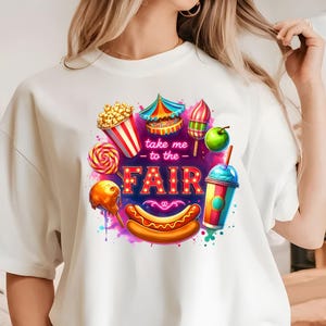 May include: White t-shirt with a colorful graphic design of carnival food and the text "Take me to the Fair".