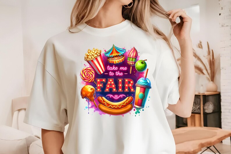 May include: White t-shirt with a colorful graphic design of carnival food and the text "Take me to the Fair".