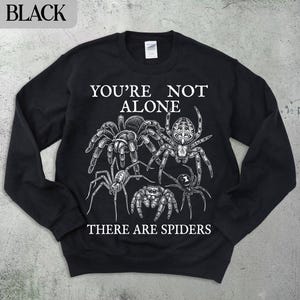 Black sweatshirt with spiders and "You're not alone, there are spiders" text.