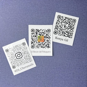 May include: Three white QR code cards on a blue textured surface. One card reads "@Di_Cherunails", another "El Rincón del Peluquero", and the third "Kenya Gil". Each card features a unique black and white QR code.