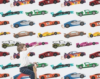 May include: A white background with a repeating pattern of colorful cartoon race cars. The cars are in various colors, including red, blue, green, orange, and yellow. The cars have numbers and words like "Racing" and "Super" on them. A young child is riding a red tricycle in the foreground.