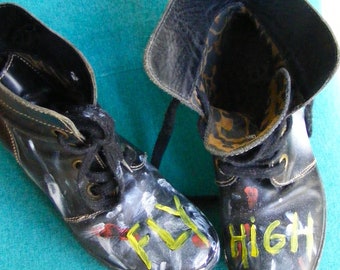 Now on sale! Refashioned Fly London black leather women's boots.  Splattered paint, bright yellow words, FLY HIGH.  Size 38 lace up.
