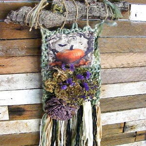 Hand knit small harvest fringed wall hanging, handstitched patch of a pumpkin and bat.