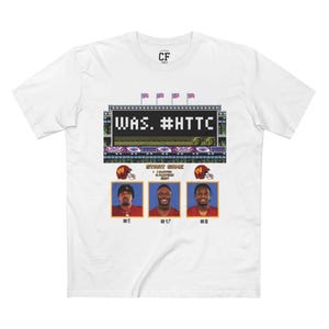 May include: White t-shirt with a pixelated image of a football stadium scoreboard with the text "WAS. #HTTC" and three football players in red and gold uniforms. The players are numbered 5, 17, and 8.