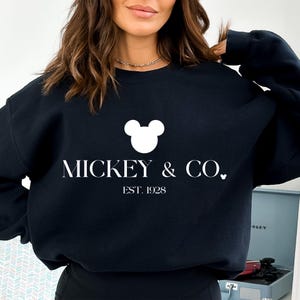 May include: Black sweatshirt with a white Mickey Mouse head and the text "MICKEY & CO. EST. 1928"