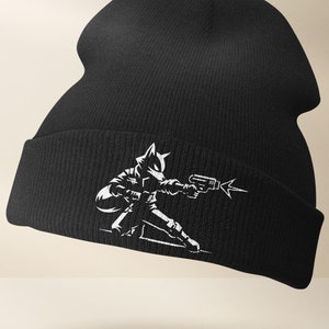 May include: Black beanie with a white graphic of a stylized fox holding a gun.