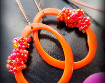 Solid orange Tagua thin hoop slice earrings. Thin slice of Tagua nut, large earwires, non allergy, crystal encrusted natural jewelry.