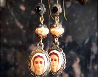 Demure little vintage brass earrings with portrait of a mysterious lady. Crucifix on the back. Sepia tones