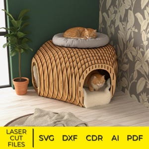 May include: A wooden cat house with a layered design, featuring a sleeping ginger cat on top and another inside. The house has a rounded shape with openings and a soft bed inside. The words "LASER CUT FILES" and file type abbreviations are at the bottom.