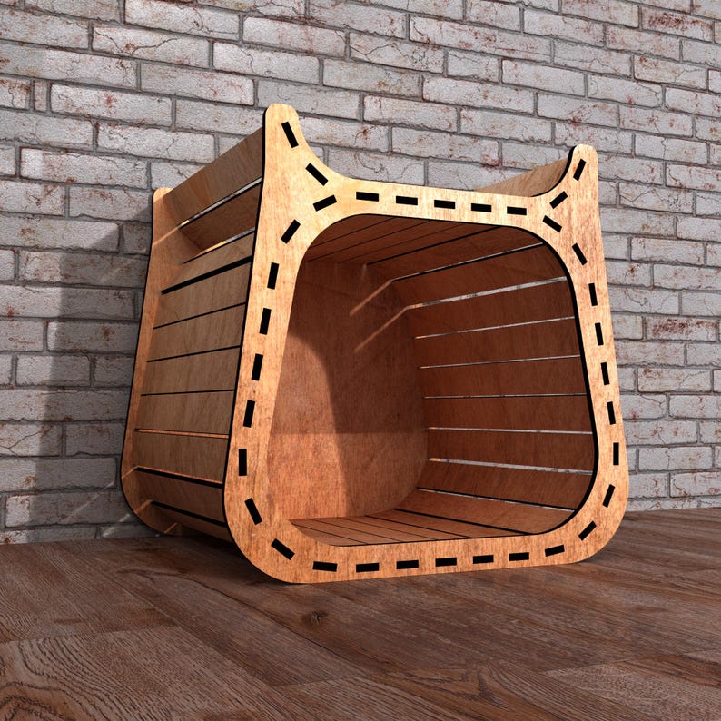 May include: A wooden storage bin with a curved design and a slatted front. The bin is made of light brown wood and has a decorative dashed line around the edges. The bin is placed on a wooden floor against a brick wall.