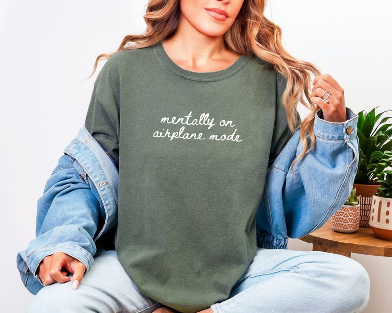 Comfort Colors 1717 t-shirt with the text “Mentally on Airplane Mode”, minimal travel-themed design. Funny airplane mode shirt for travel lovers, airport outfits, vacations, flights, introverts, and everyday casual wear.