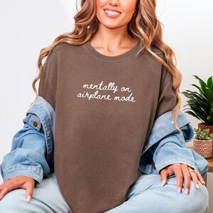 Comfort Colors 1717 t-shirt with the text “Mentally on Airplane Mode”, minimal travel-themed design. Funny airplane mode shirt for travel lovers, airport outfits, vacations, flights, introverts, and everyday casual wear.