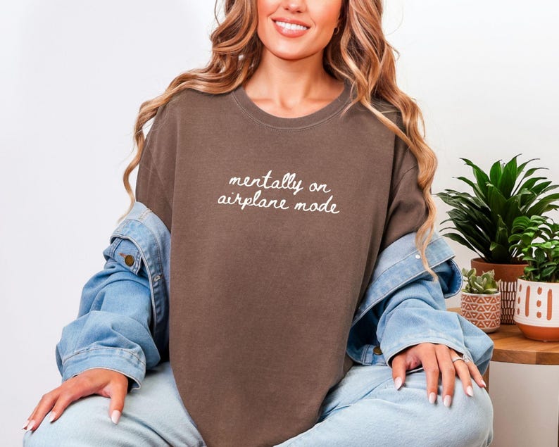 Comfort Colors 1717 t-shirt with the text “Mentally on Airplane Mode”, minimal travel-themed design. Funny airplane mode shirt for travel lovers, airport outfits, vacations, flights, introverts, and everyday casual wear.