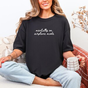 Comfort Colors 1717 t-shirt with the text “Mentally on Airplane Mode”, minimal travel-themed design. Funny airplane mode shirt for travel lovers, airport outfits, vacations, flights, introverts, and everyday casual wear.