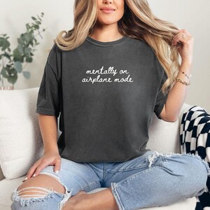 Comfort Colors 1717 t-shirt with the text “Mentally on Airplane Mode”, minimal travel-themed design. Funny airplane mode shirt for travel lovers, airport outfits, vacations, flights, introverts, and everyday casual wear.