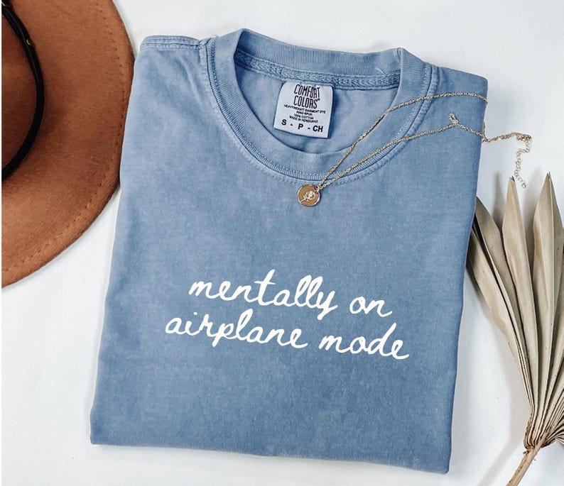 Comfort Colors 1717 t-shirt with the text “Mentally on Airplane Mode”, minimal travel-themed design. Funny airplane mode shirt for travel lovers, airport outfits, vacations, flights, introverts, and everyday casual wear.