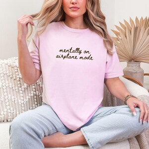 Comfort Colors 1717 t-shirt with the text “Mentally on Airplane Mode”, minimal travel-themed design. Funny airplane mode shirt for travel lovers, airport outfits, vacations, flights, introverts, and everyday casual wear.