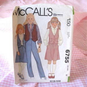 May include: A McCall's 6755 sewing pattern envelope for girl's clothing. The front features illustrations of three children wearing vests, skirts, pants, and shirts. The text includes the brand name, pattern number 6755, and size 14.