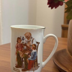 Vintage 1982 Norman Rockwell ‘The Toymaker’ Porcelain Tea Cup Mug- The Norman Rockwell Classic Mug Collector’s Series- White with Gold Trim