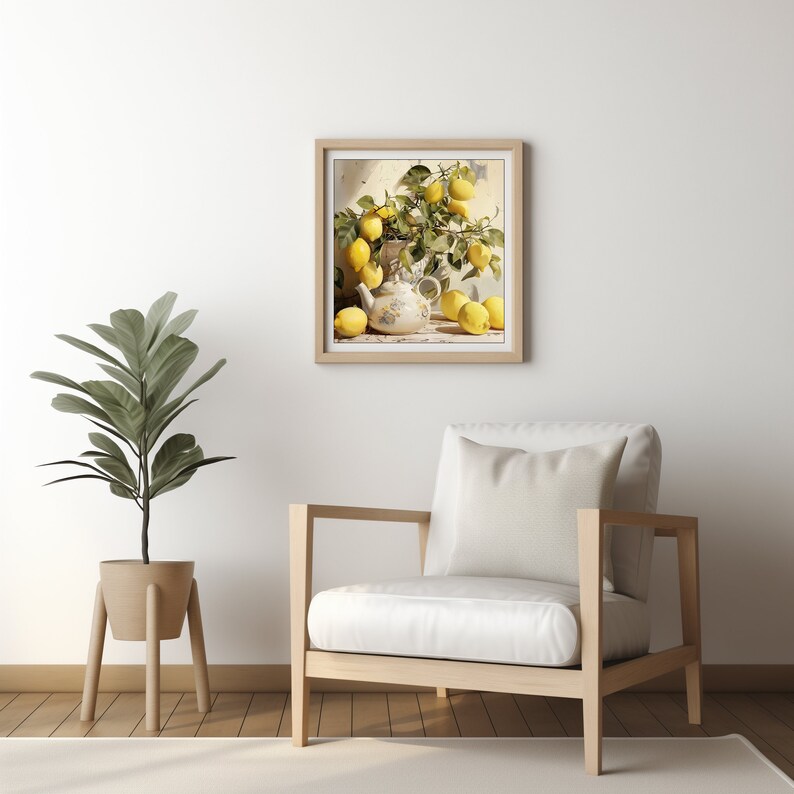 May include: A framed painting of a white teapot filled with lemons and a branch of lemon leaves. The painting is hanging on a white wall above a white armchair with a white pillow.