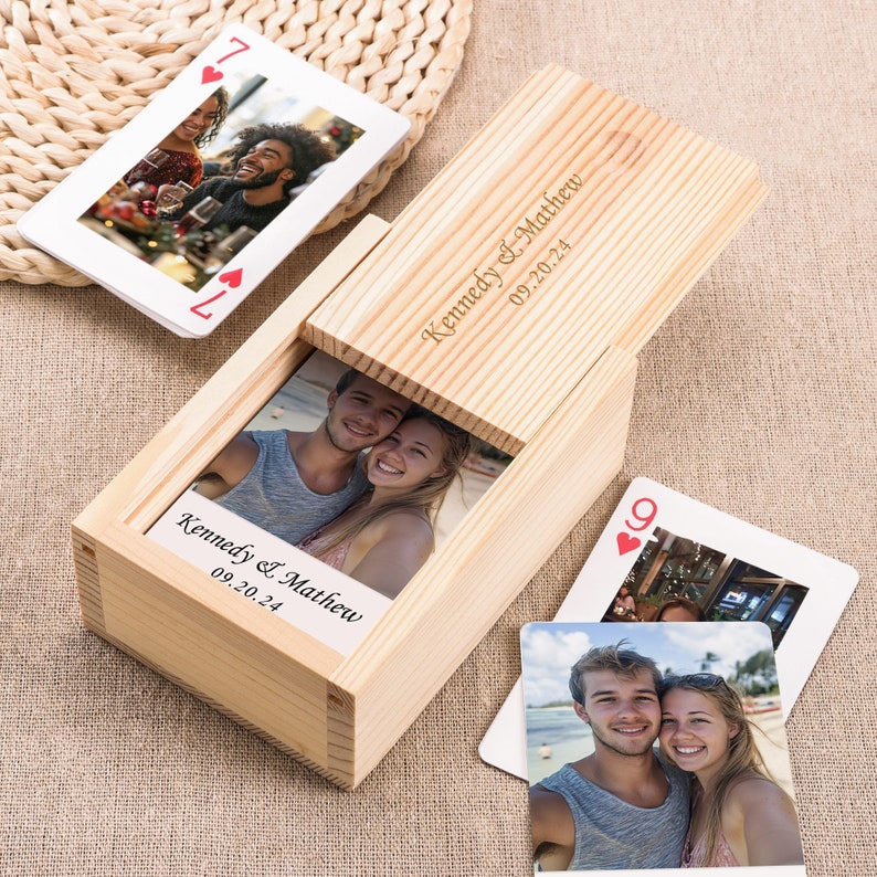 May include: A wooden box with a hinged lid, engraved with the names "Kennedy & Matthew" and the date "09.20.24". The box contains a deck of playing cards with photos of a couple on each card.