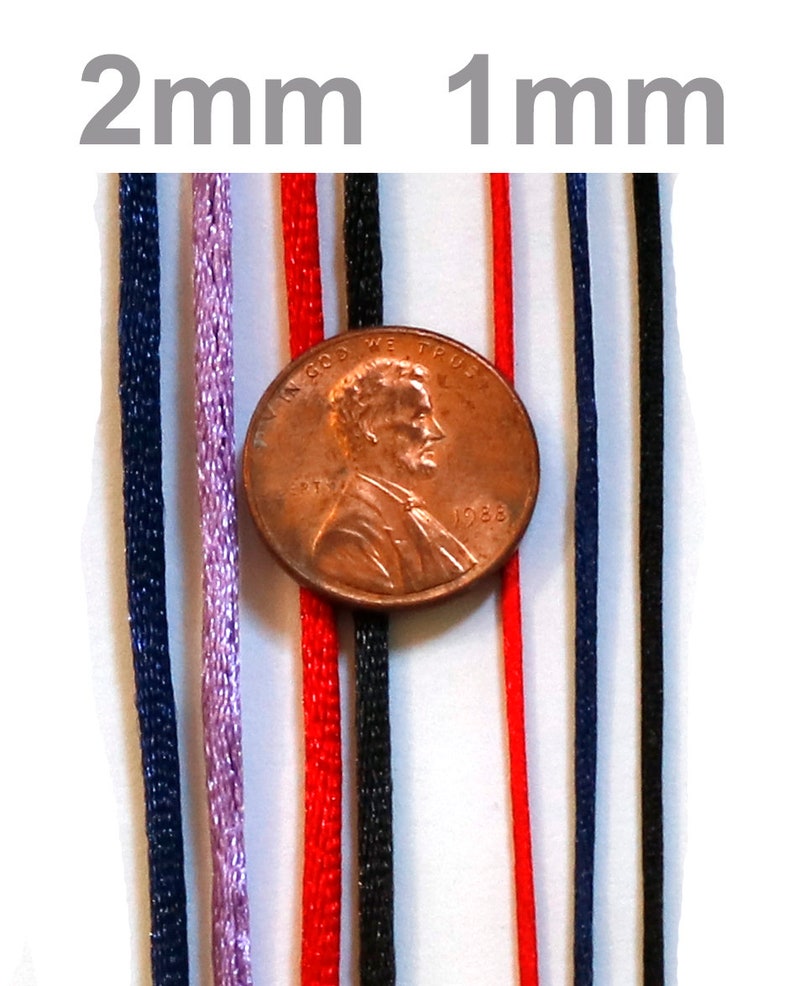 May include: A close-up of eight different colored cords, ranging in thickness from 1 mm to 2 mm. The cords are arranged vertically and are next to a US penny for scale.