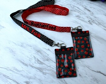 May include: Black and red polka dot lanyard with the text "Mrs. Funk Rutherford" embroidered in red. Two black and red polka dot ID badge holders with clear plastic windows and a red apple pattern.
