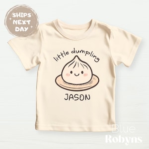 “Little Dumpling” baby onesie with custom name

Cute dumpling baby outfit for newborns and toddlers

Personalized food pun onesie for baby

Asian-inspired baby clothes with dumpling design