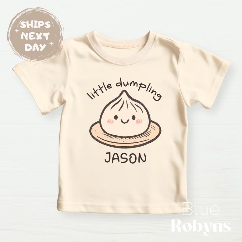 “Little Dumpling” baby onesie with custom name

Cute dumpling baby outfit for newborns and toddlers

Personalized food pun onesie for baby

Asian-inspired baby clothes with dumpling design