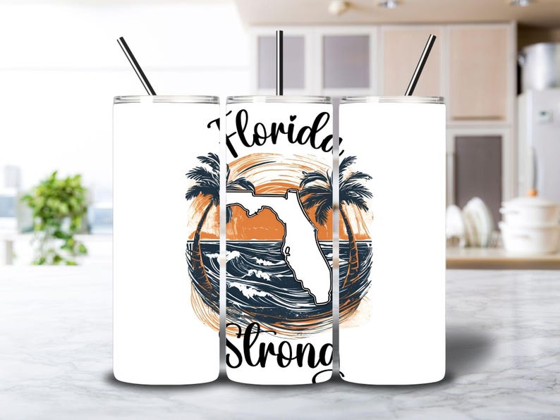 May include: Three white stainless steel tumblers with a graphic of a palm tree, the state of Florida, and the words "Florida Strong".