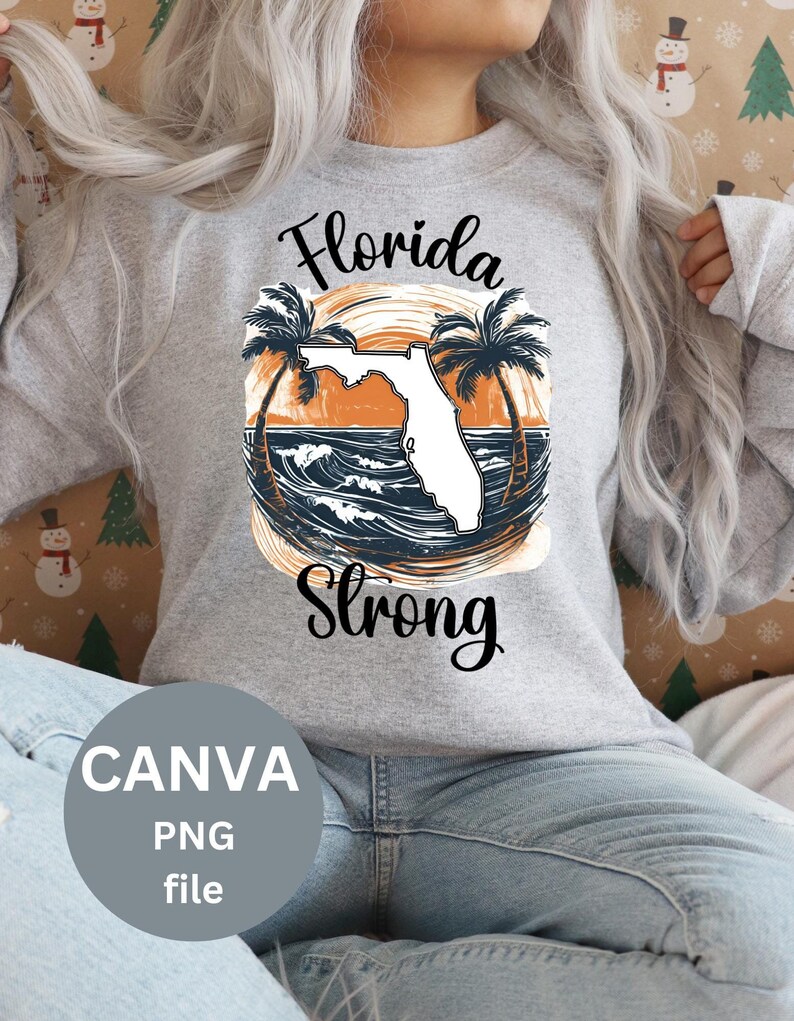 May include: A gray sweatshirt with the text "Florida Strong" in black lettering. The design features a white outline of the state of Florida with palm trees and an orange sunset in the background.