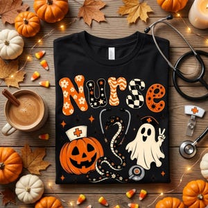 May include: A black t-shirt featuring the word Nurse in orange and black patterned letters. Below, a jack-o'-lantern wearing a nurse cap, a snake coiled around a stethoscope, and a ghost making a peace sign are printed in orange and white.