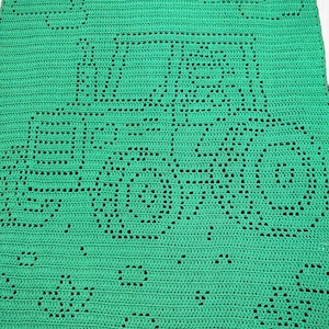 May include: A bright green crochet blanket featuring a central tractor design created with openwork stitches. The pattern includes two clouds positioned above the tractor and several small flower motifs scattered across the bottom section of the fabric.
