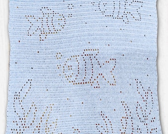May include: A rectangular light blue crochet blanket featuring an intricate openwork pattern that depicts three fish swimming among seaweed. The design is created using a filet crochet technique, resulting in a textured, semi-sheer fabric.