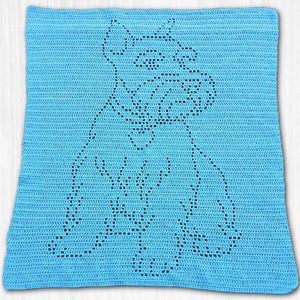 May include: A rectangular light blue crochet blanket featuring a central openwork design that forms the silhouette of a seated dog. The pattern is created using a series of small holes within the solid stitch work of the fabric.