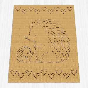 May include: A rectangular tan crochet blanket featuring a dark brown pattern of a large hedgehog standing next to a smaller hedgehog. The design includes a horizontal row of small heart shapes along the top and bottom edges of the blanket.