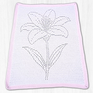 May include: A rectangular white crochet blanket featuring a centered floral design created with openwork stitches. The blanket is finished with a solid light pink border that frames the entire piece, providing a distinct contrast to the white center.