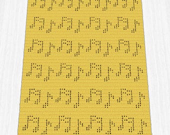May include: A yellow crocheted blanket featuring a repeating pattern of musical notes in dark brown. The blanket is rectangular and appears to be handmade, with a textured surface and a musical theme.